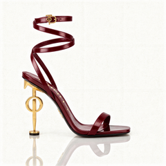 Maroon high-heeled sandal with gold accents on a white background