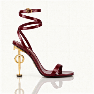 Maroon high-heeled sandal with gold accents on a white background