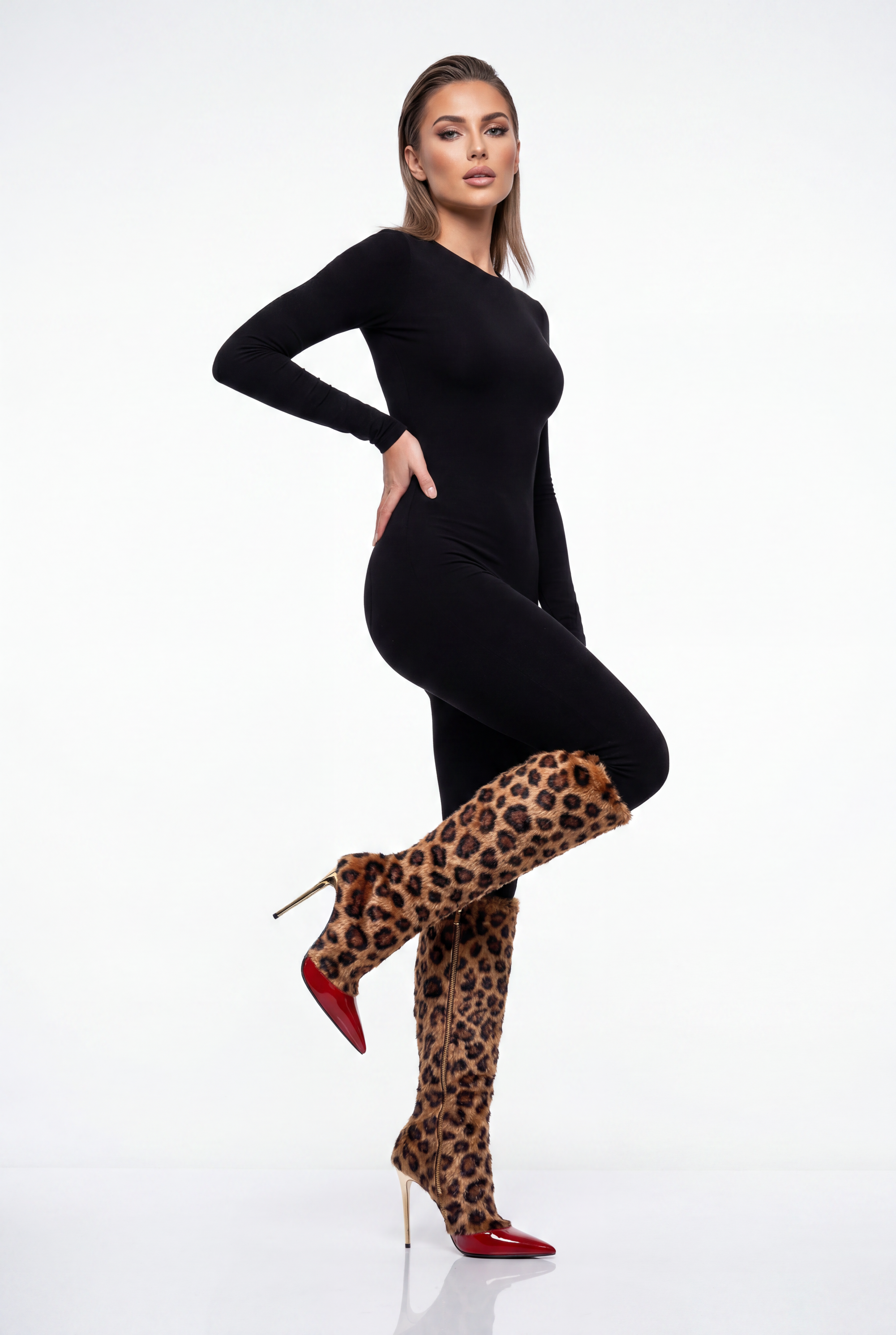 A model poses in a black long-sleeve bodysuit, leopard-print thigh-high socks, and red pointed-toe stiletto heels against a white studio background.