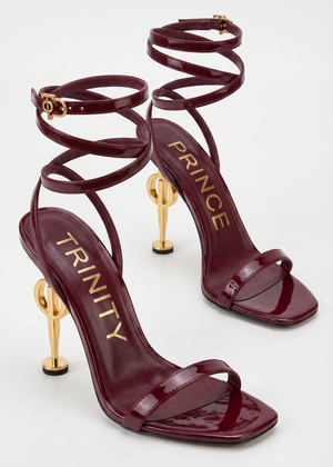 Burgundy high-heeled sandals with gold accents on a white background