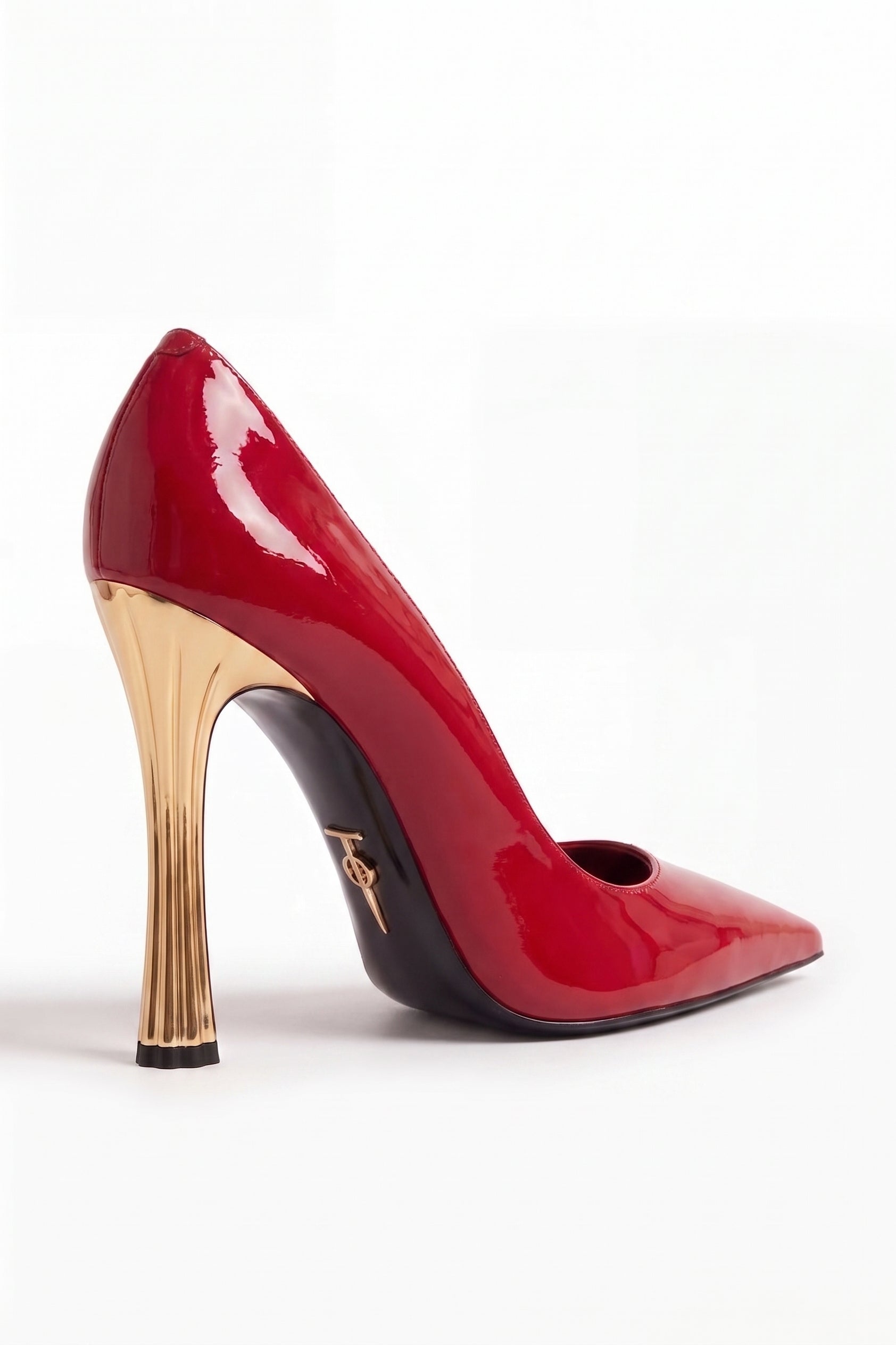 Red high-heeled shoe with gold heel on a white background